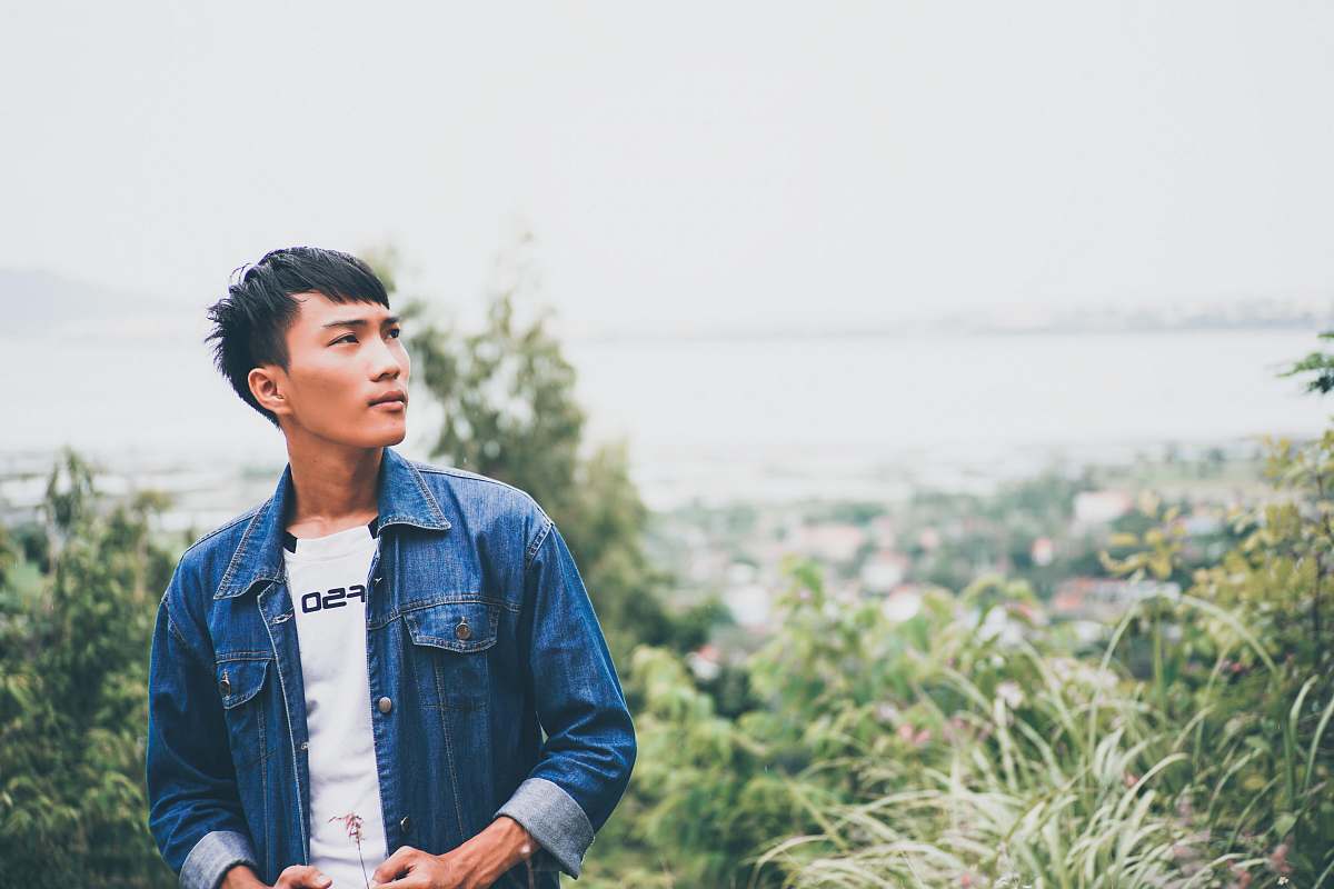 people selective focus photography of man standing near trees person