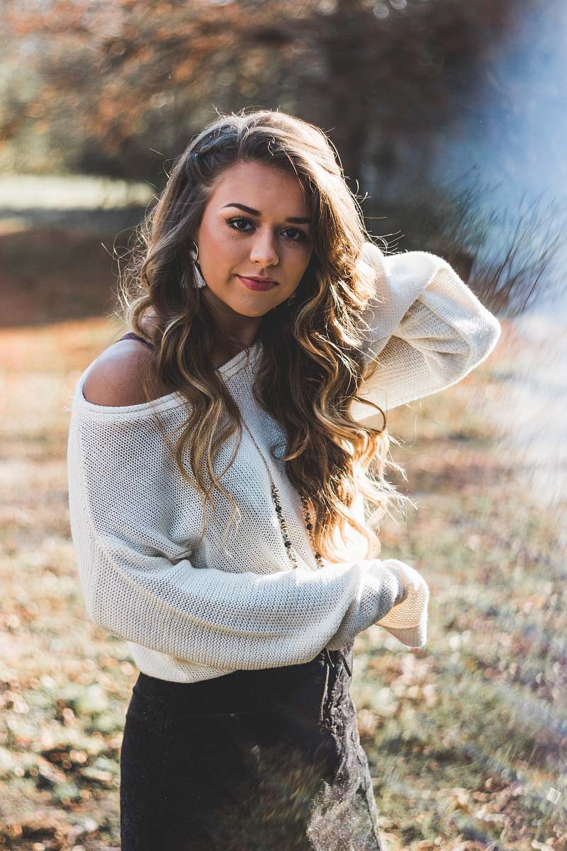 people selective focus photography of woman in white mesh top and black skirt person