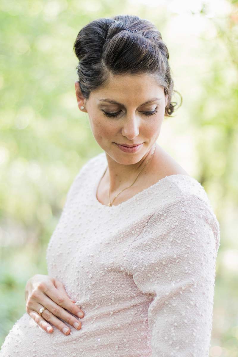 people selective focus photography pregnant woman looking down white holding her tummy person