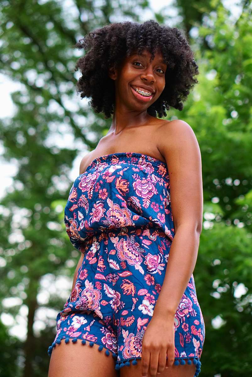 people selective focus photography woman wearing blue and pink floral tube rompers person