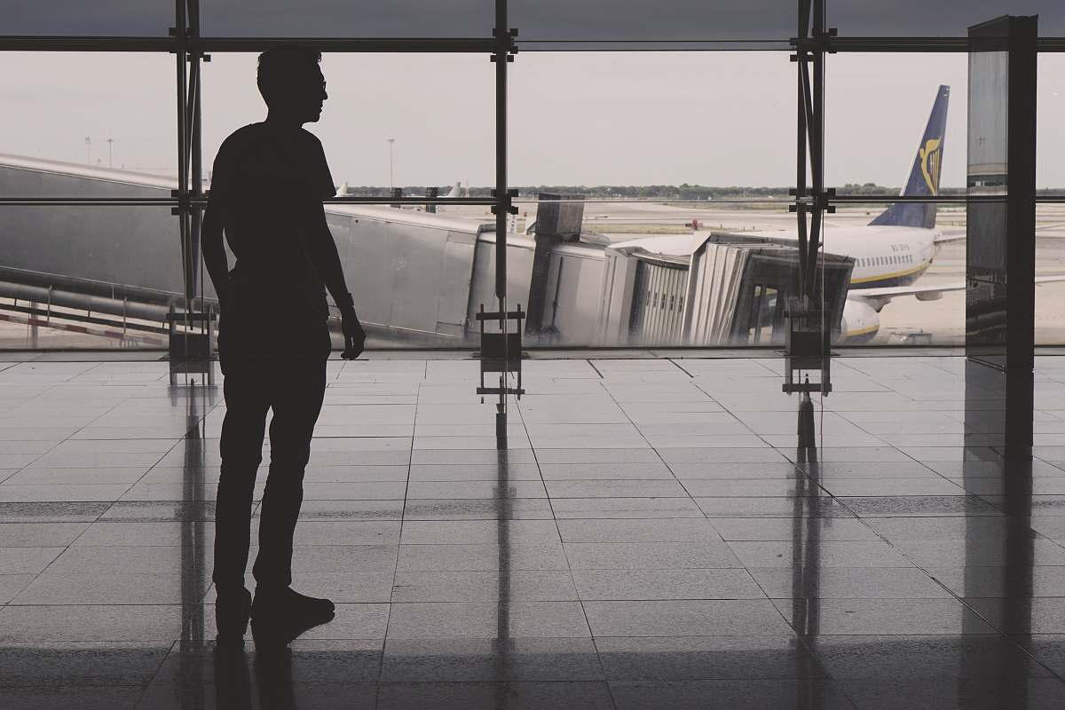 people silhouette of man on airport lounge person