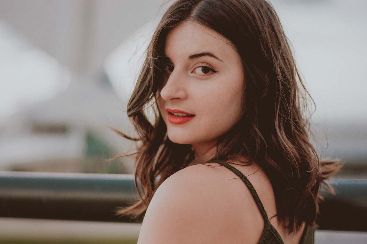people smiling woman wearing black sleeveless top person