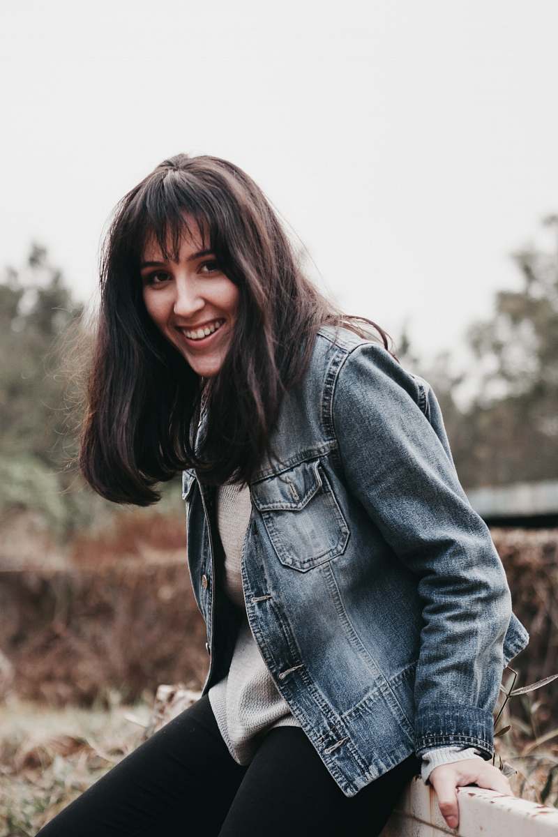 people smiling woman wearing blue chambray jacket person