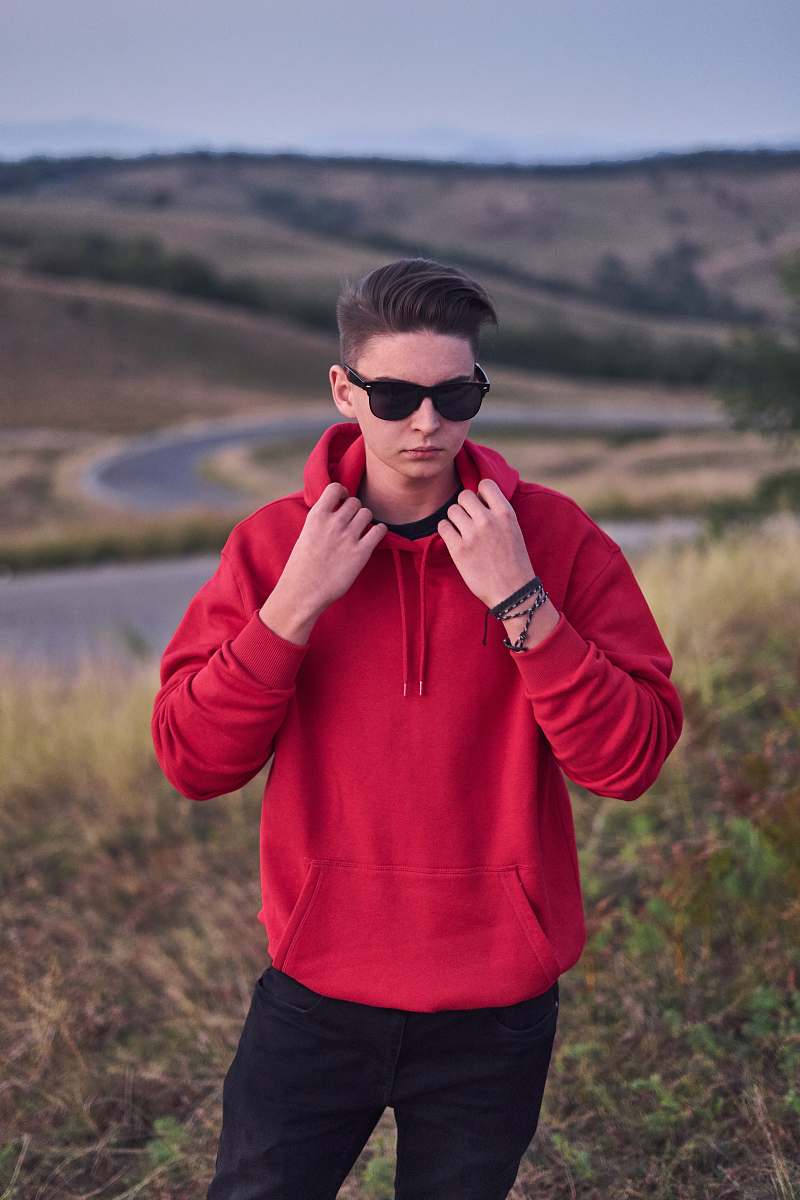 people standing man in red pullover hoodie person