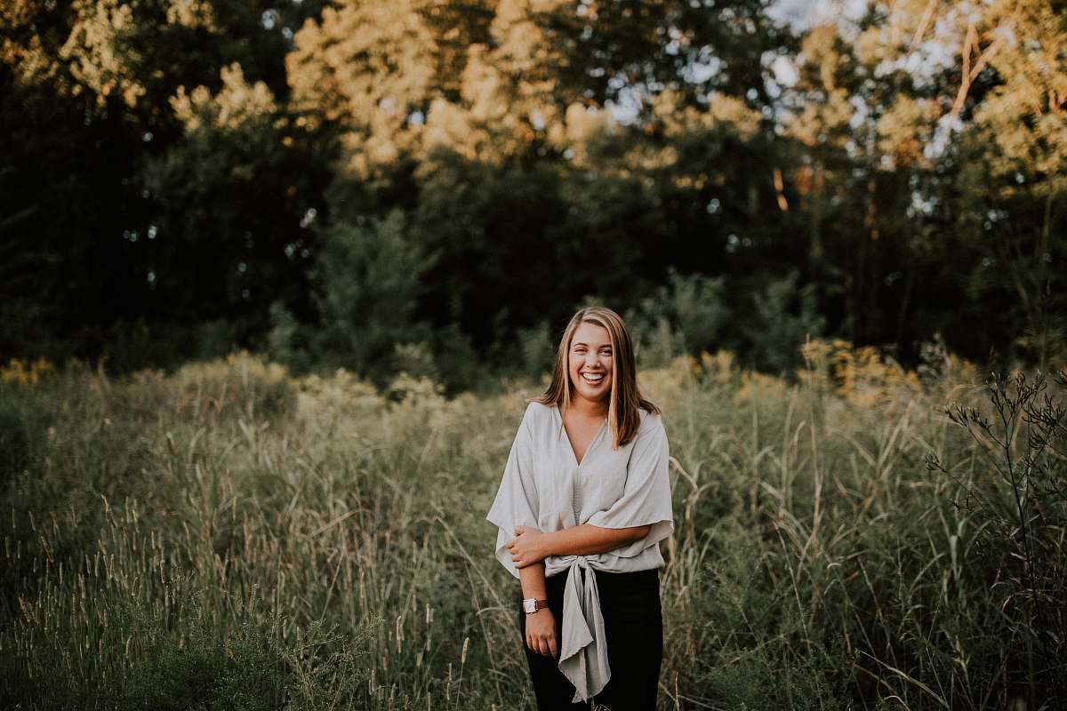 people standing woman smiling near trees at daytime person