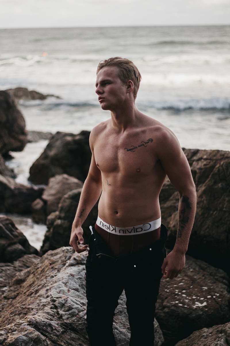 person topless man on shore people