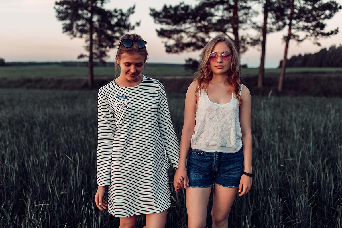 people two woman walking on grass land person