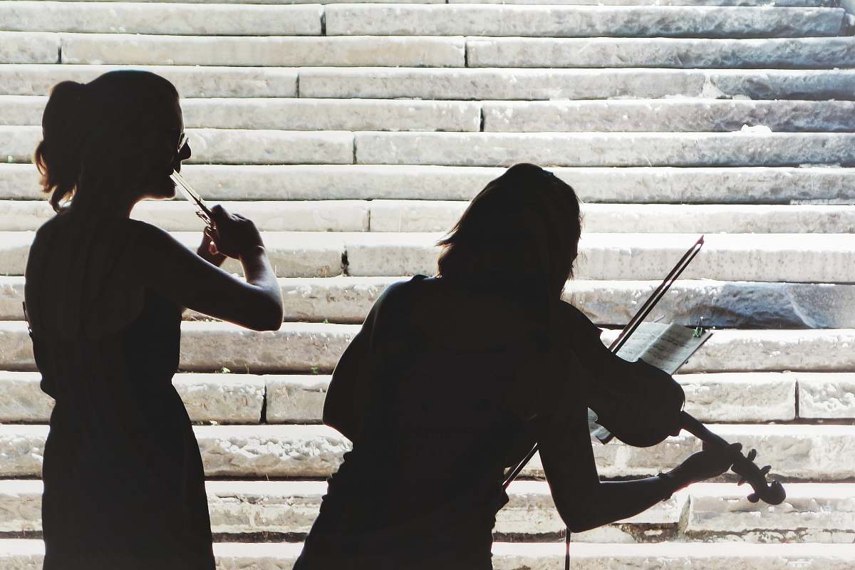 people two women playing violin and flute person
