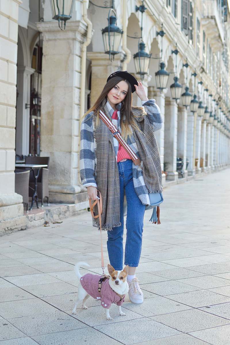 person woman and puppy standing beside building people