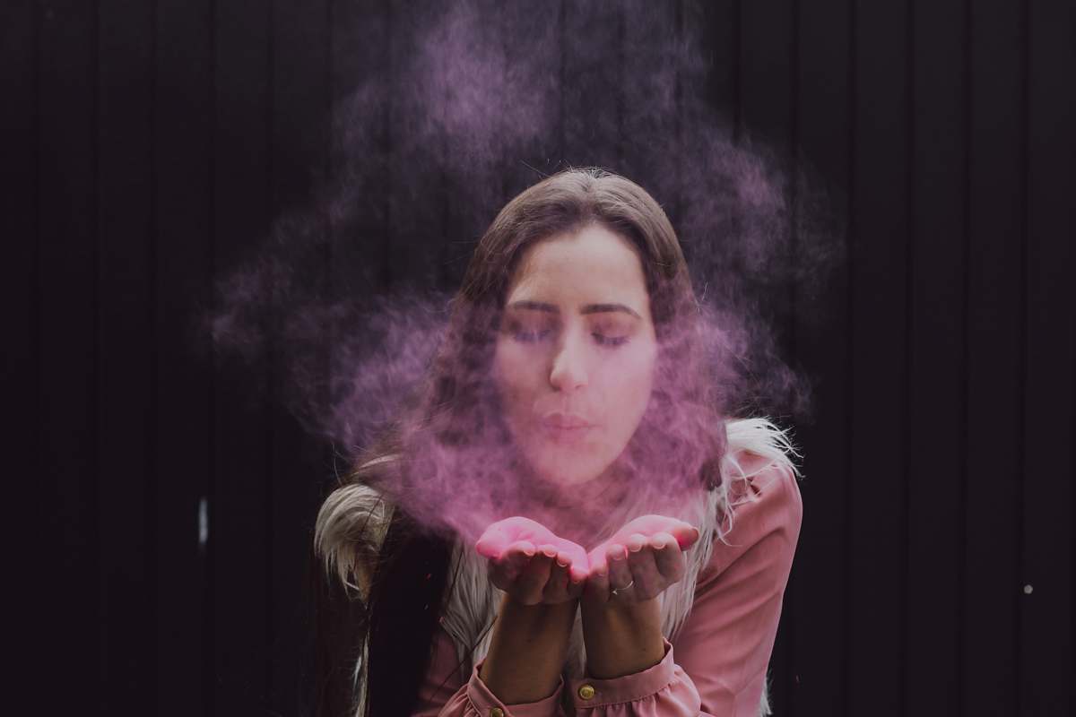people woman blowing smoke on her both hands person