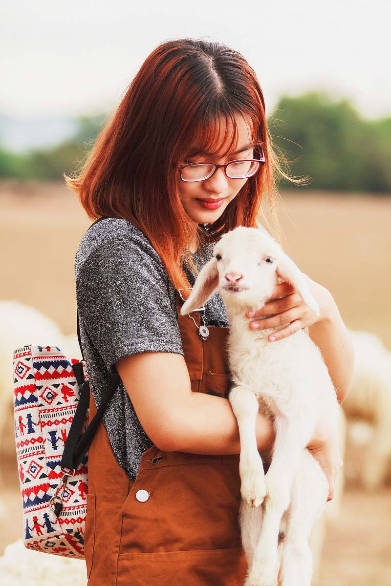 people woman carrying a goat person