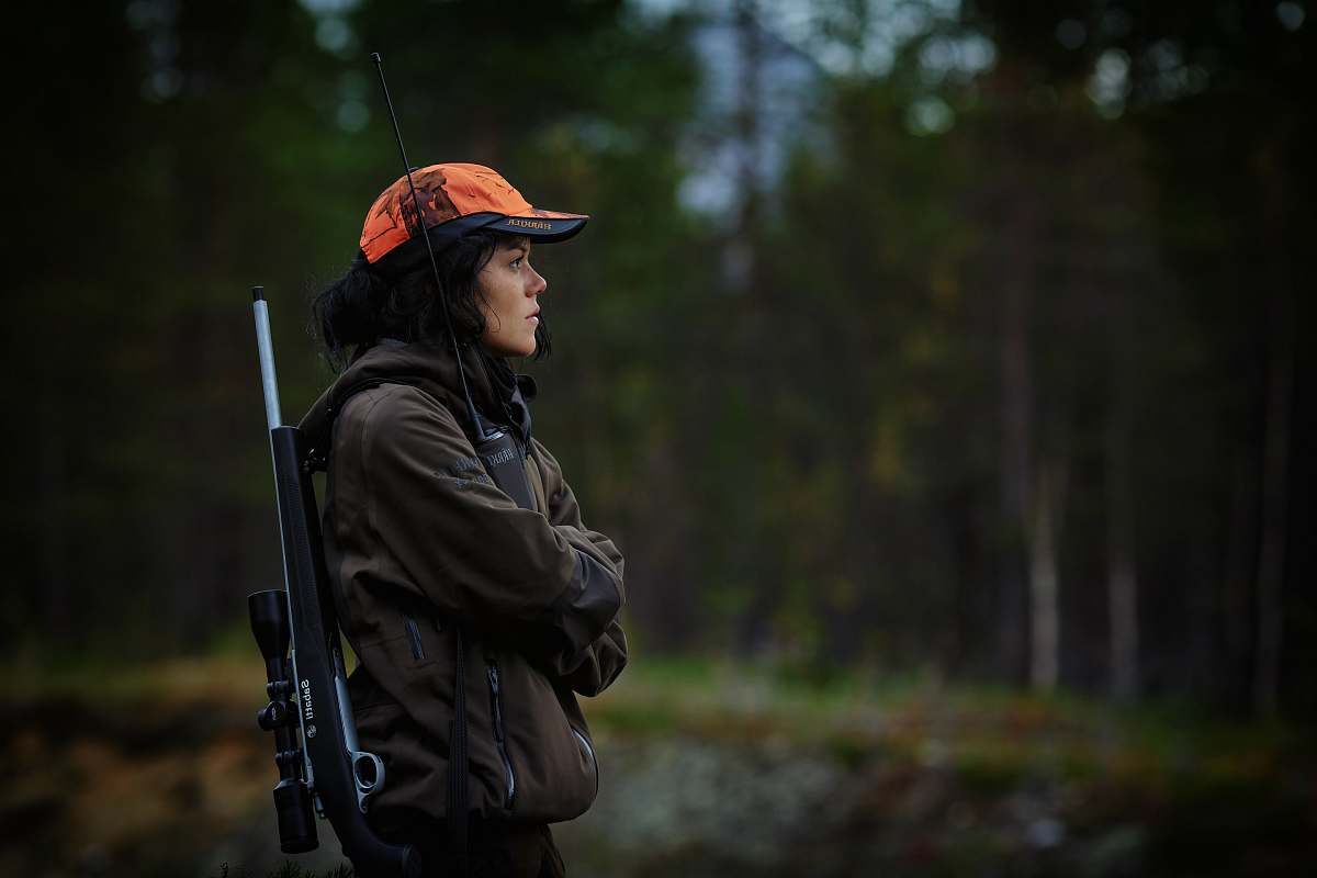 people woman carrying hunting rifle in woods person