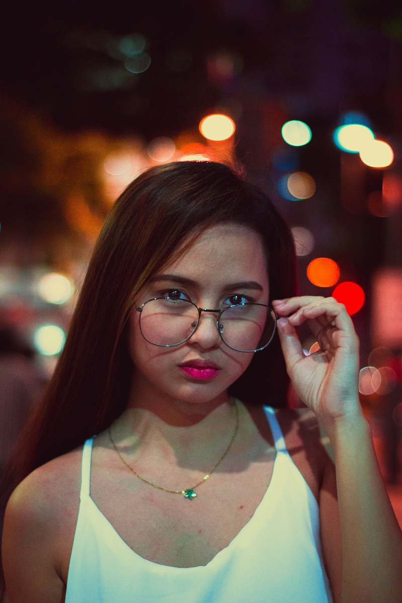 person woman holding eyeglasses people