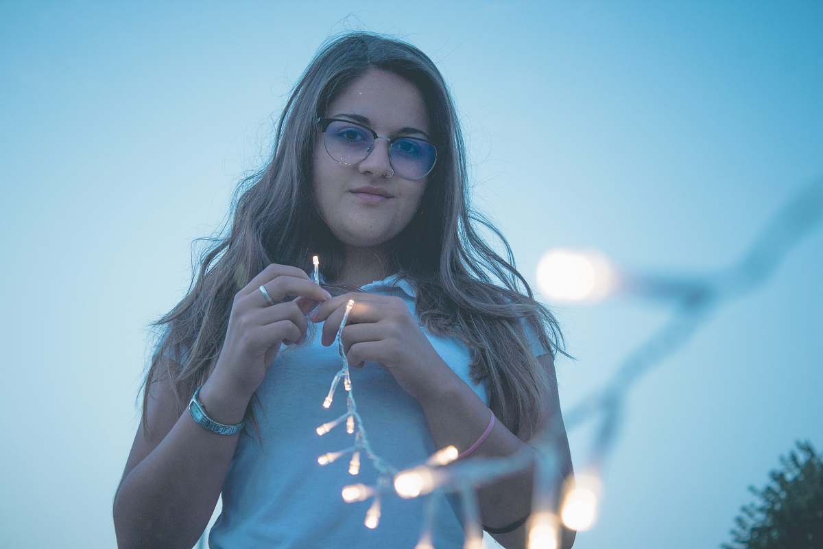 people woman holding string lights person
