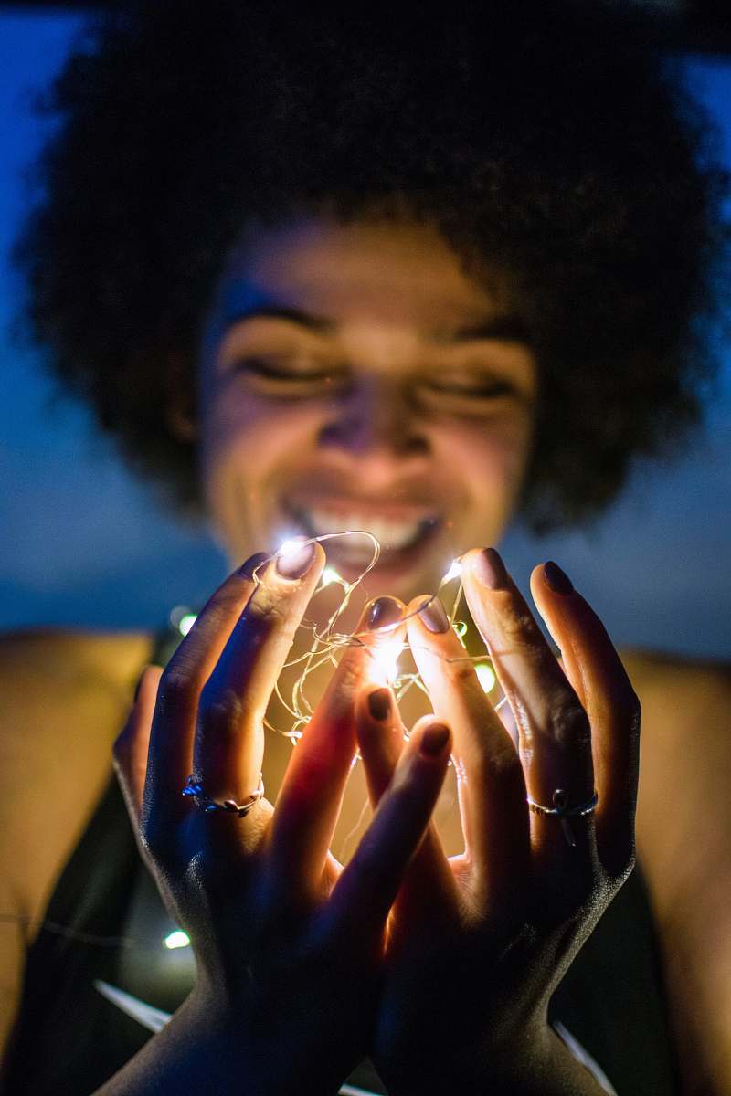 people woman holding white string lights person