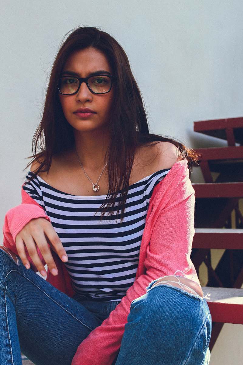 people woman in white and black striped shirt taking a selfie person