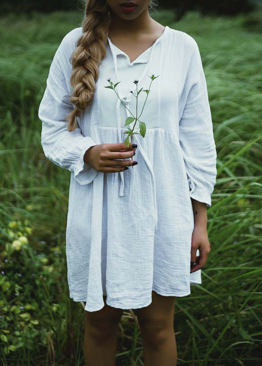 people woman in white long-sleeved dress on gras person