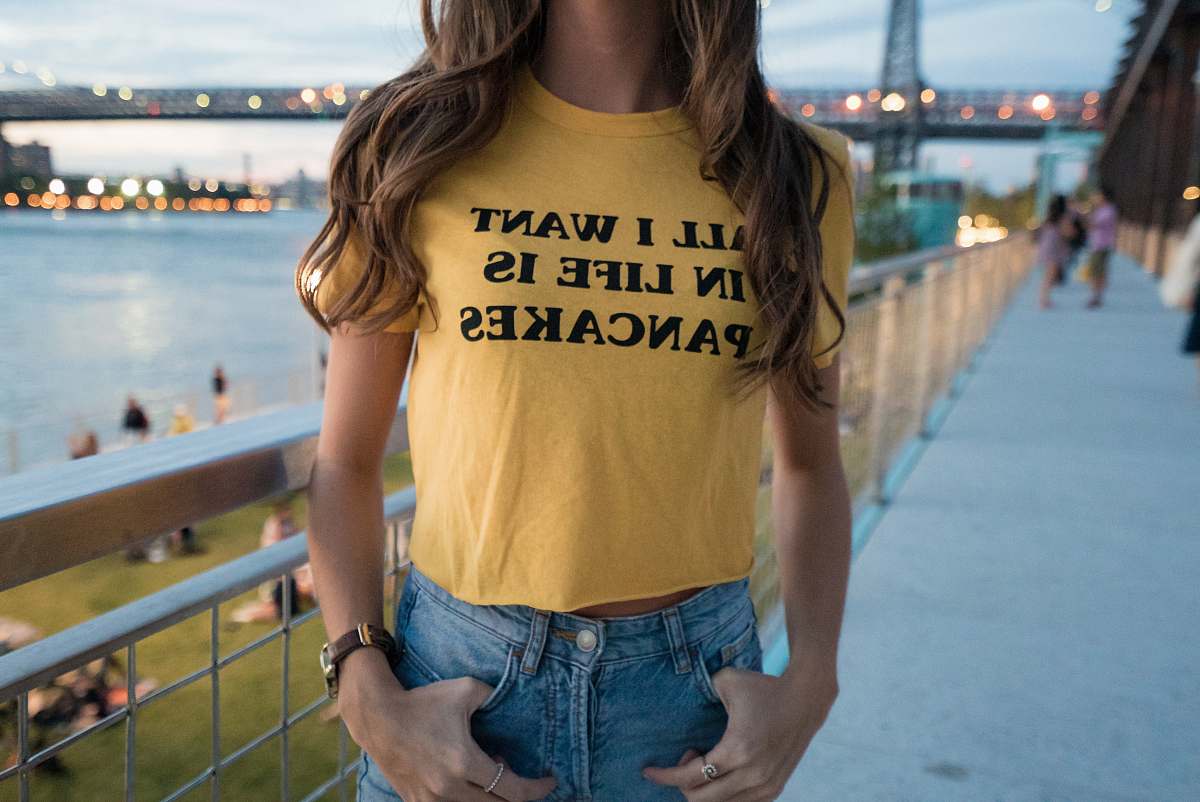 person woman in yellow crew-neck t-shirt and blue denim bottoms people