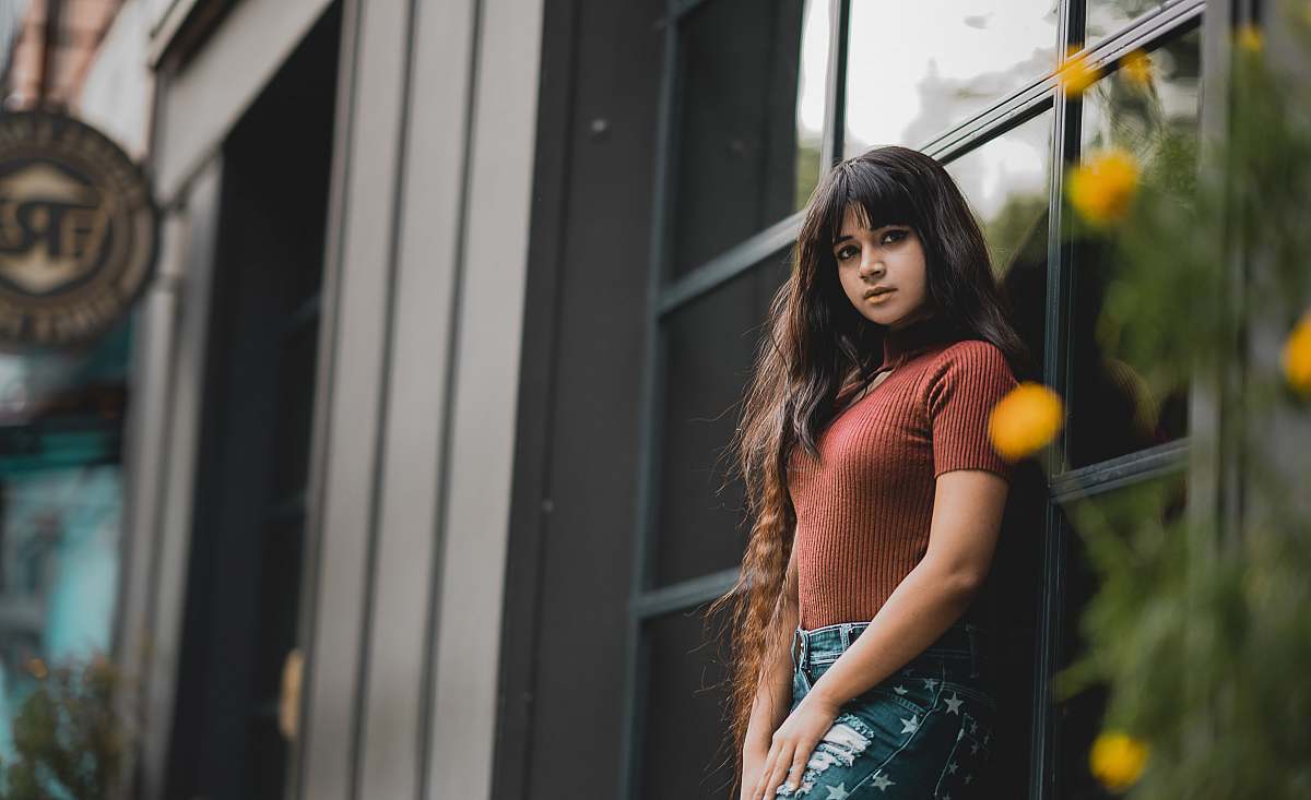 person woman leaning on glass window outdoor during daytime people