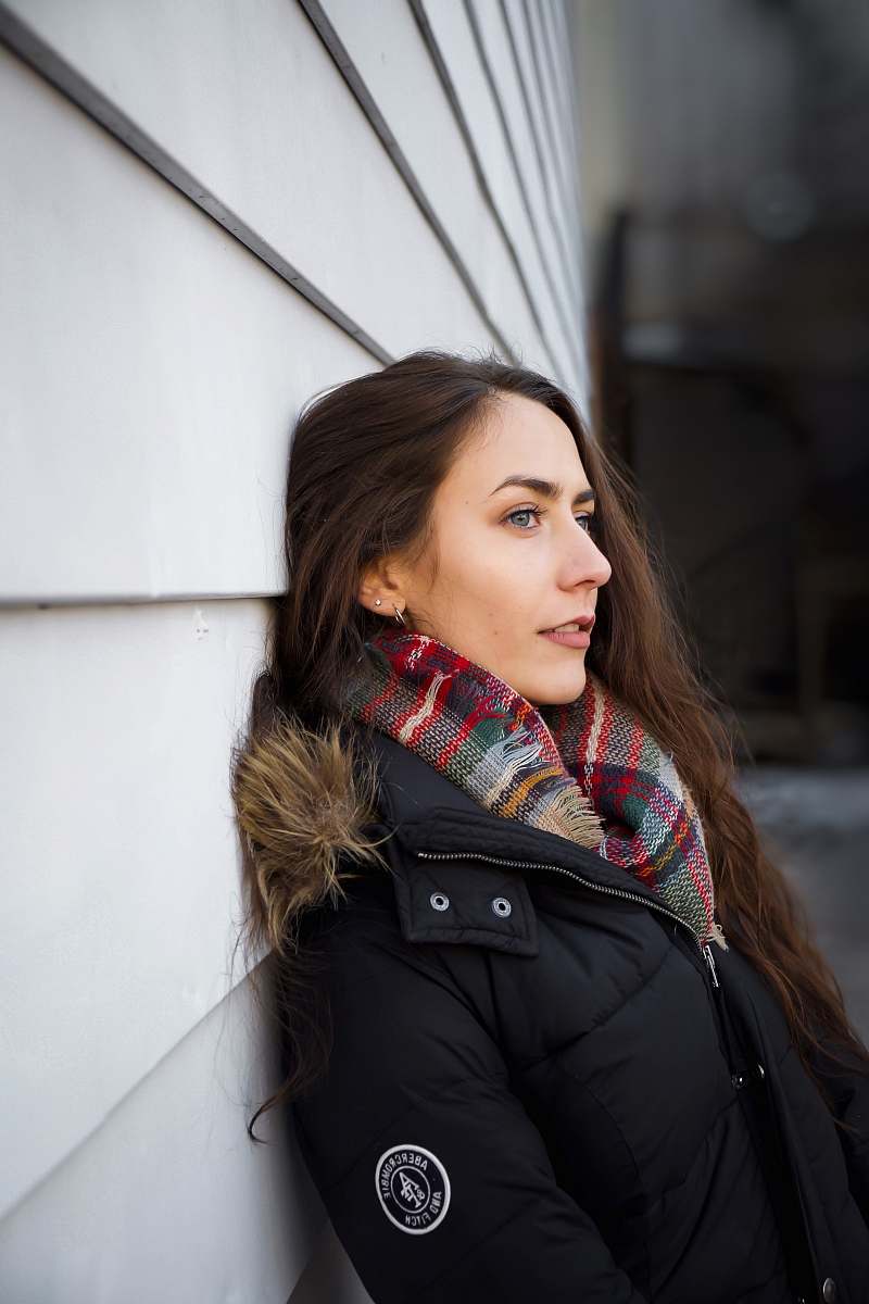 people woman leaning on white wall at daytime person