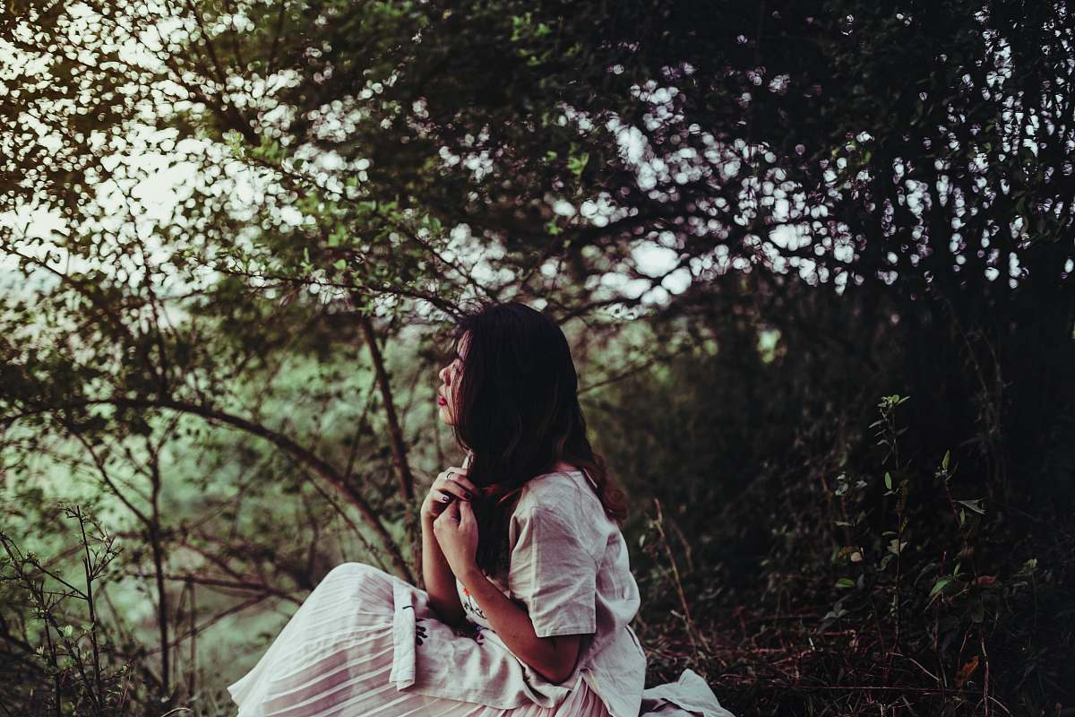 person woman sitting beside tree people