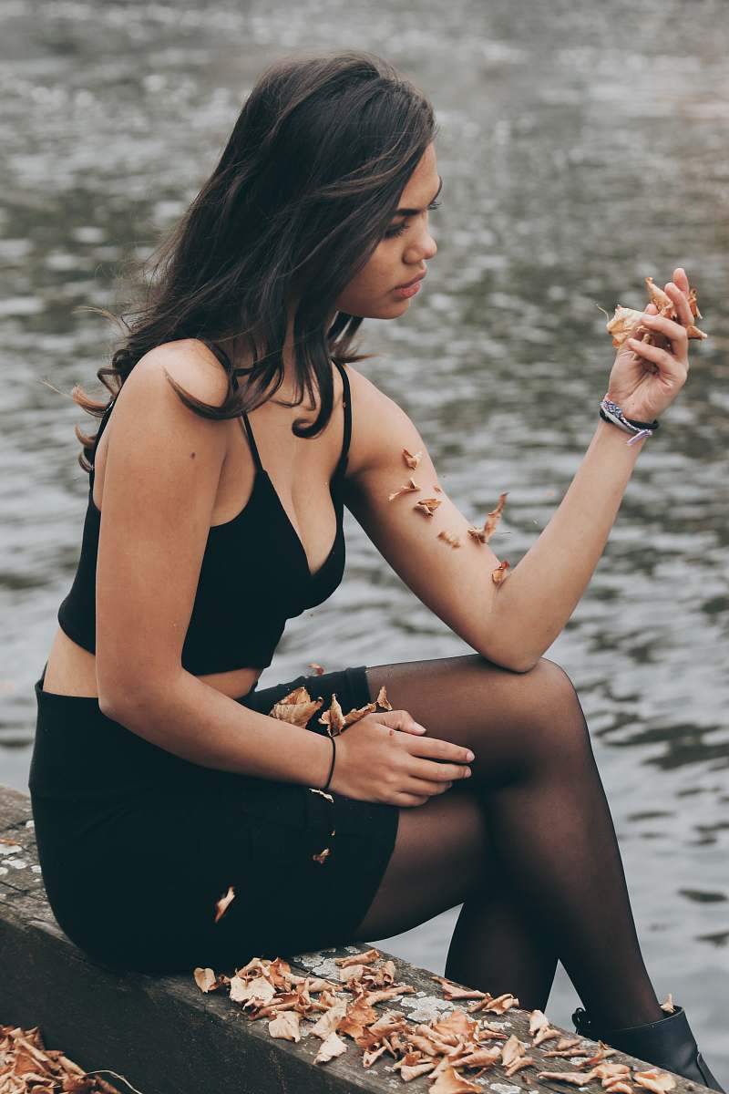 person woman sitting next to body of water people