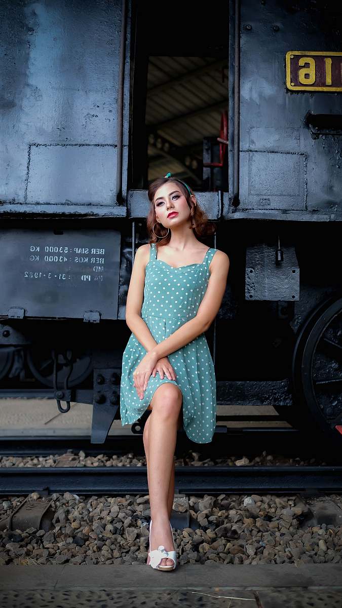people woman sitting on train posing for photoshoot person