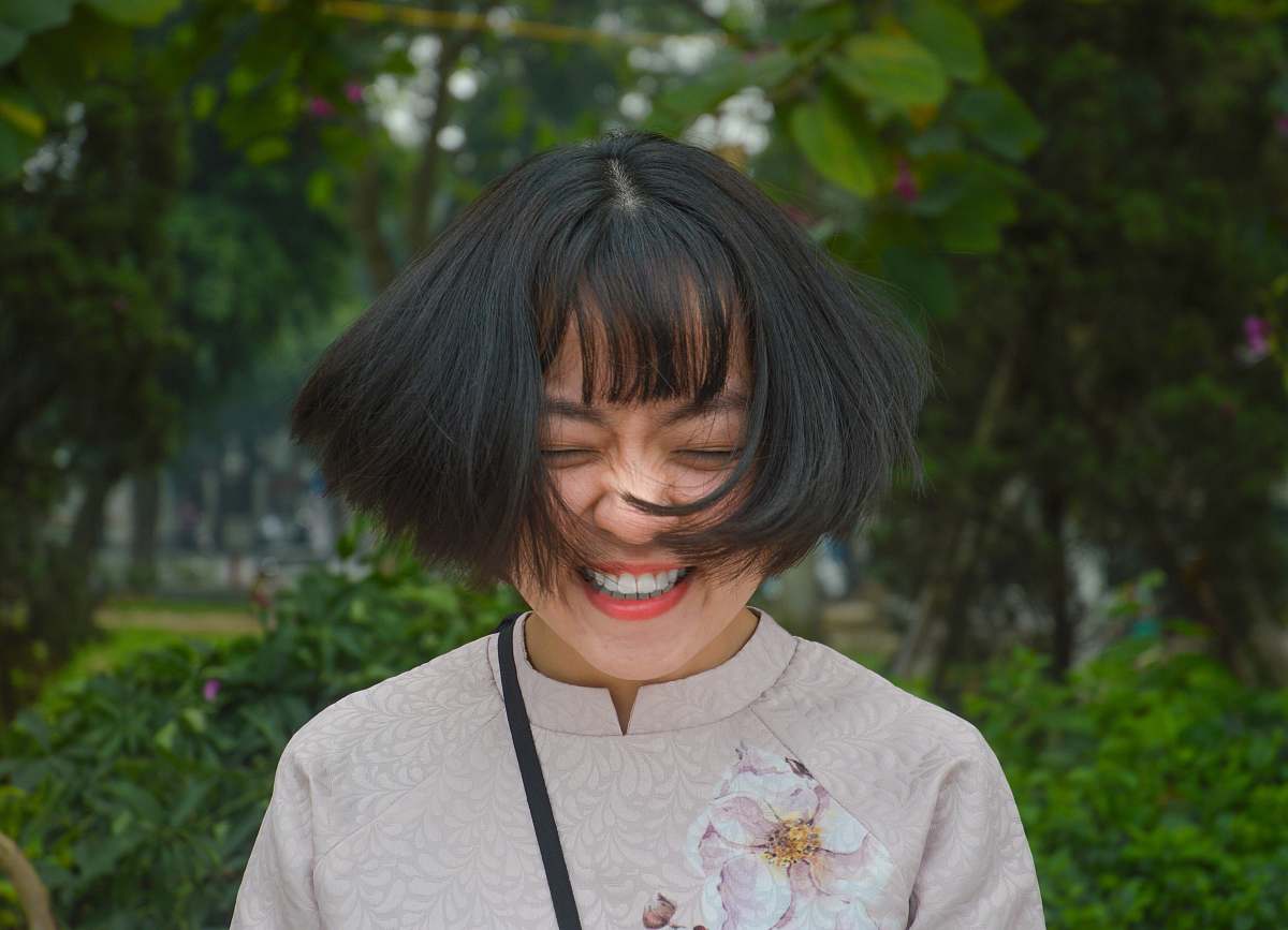 people woman smiling closing eyes while flipping her hair person