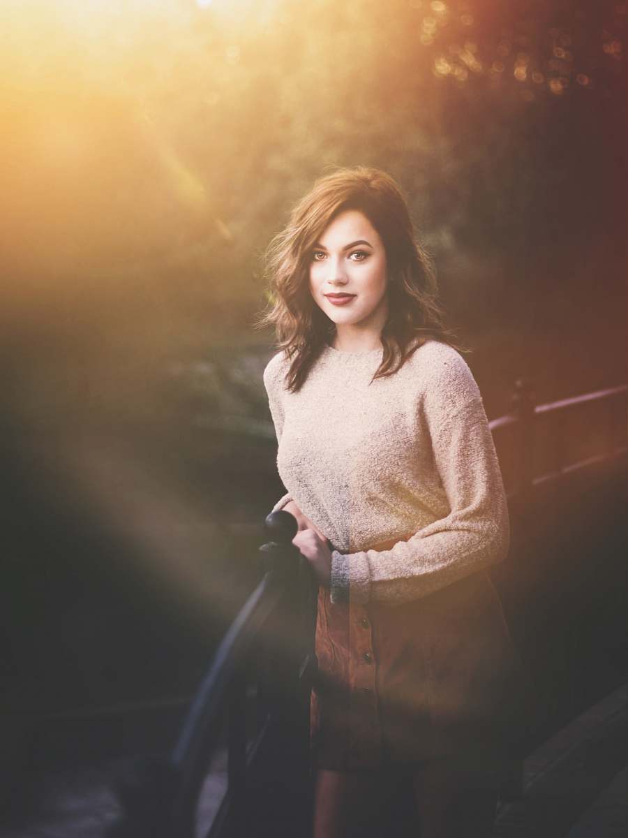 people woman standing beside black railings during daytime person