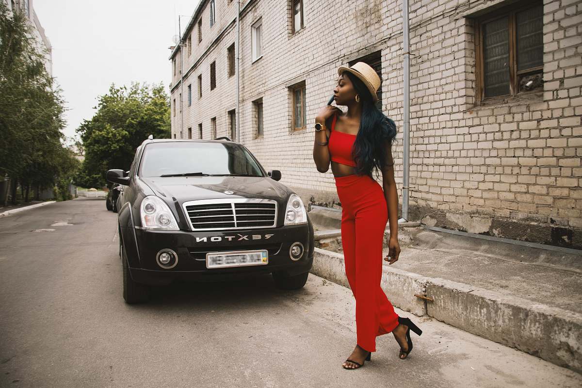 people woman standing in front of black vehicle person