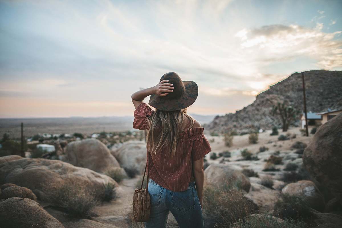 people woman standing in front of stones during daytime person
