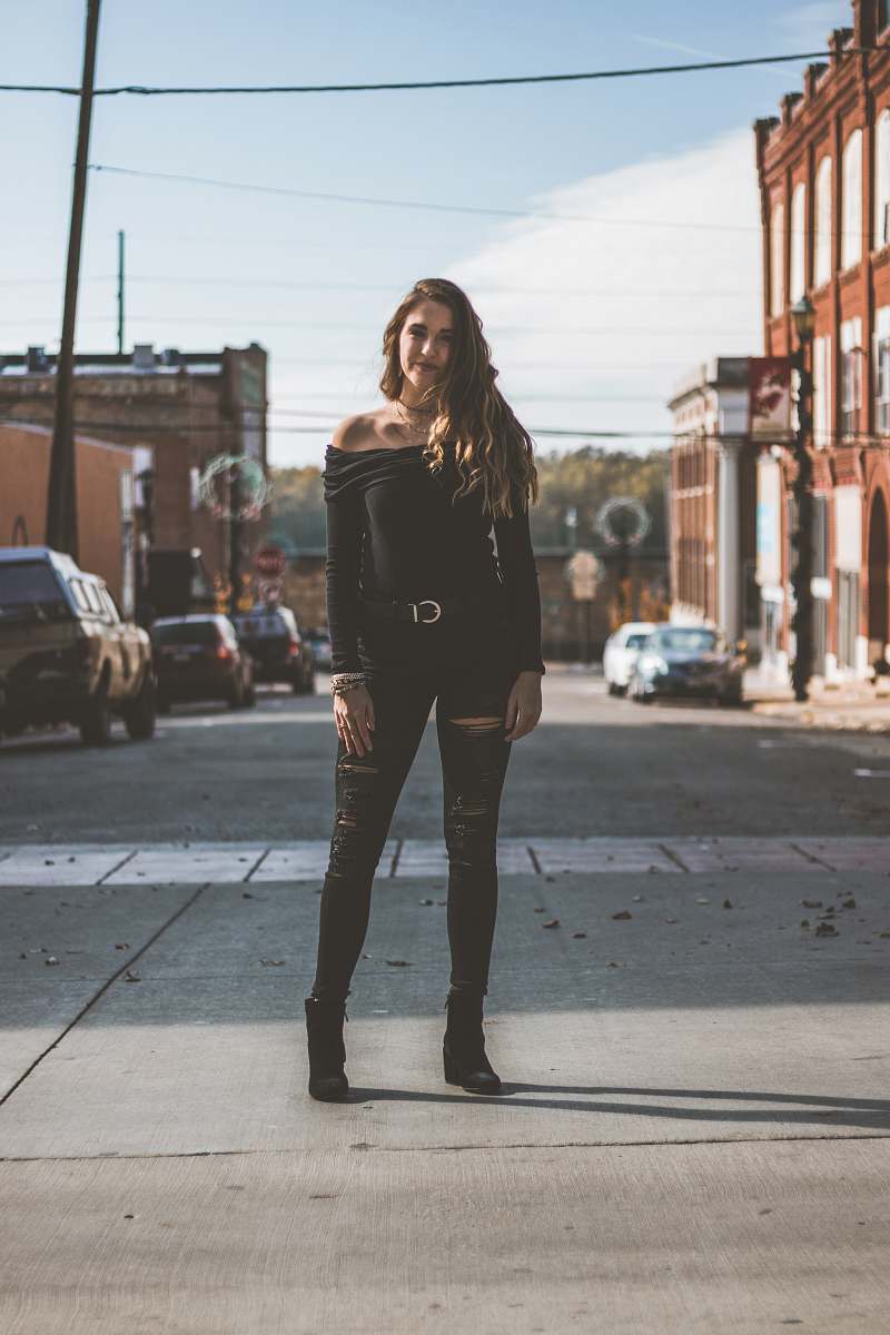 person woman standing in the middle of street people