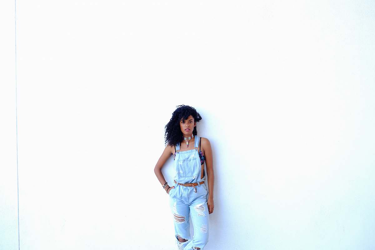 people woman standing leaning on wall person