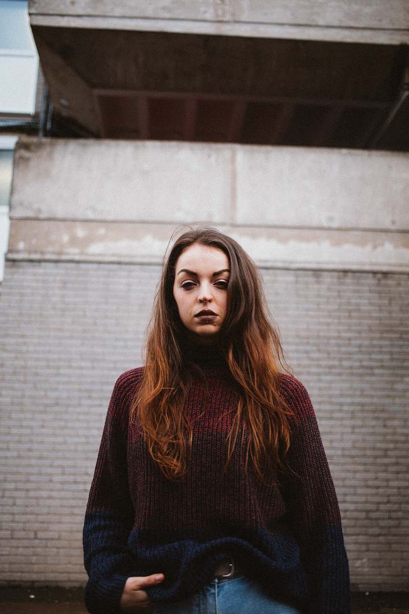 people woman standing near brown building person