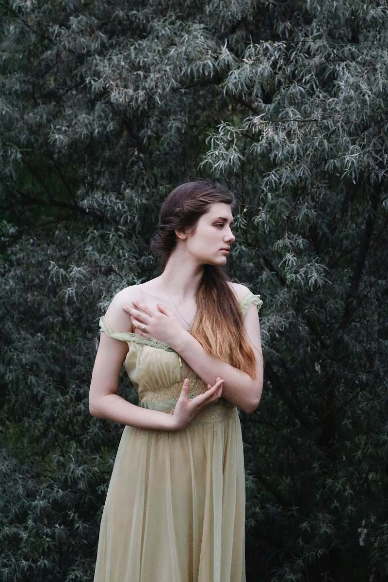 people woman standing near green leafed tree person