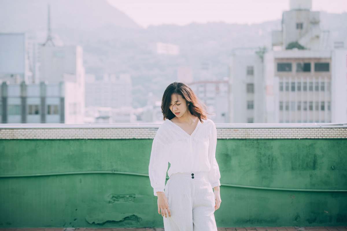 people woman standing near green wall during daytime person
