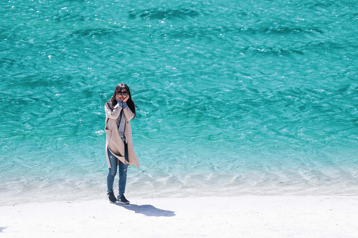 people woman standing near seashore during daytime person