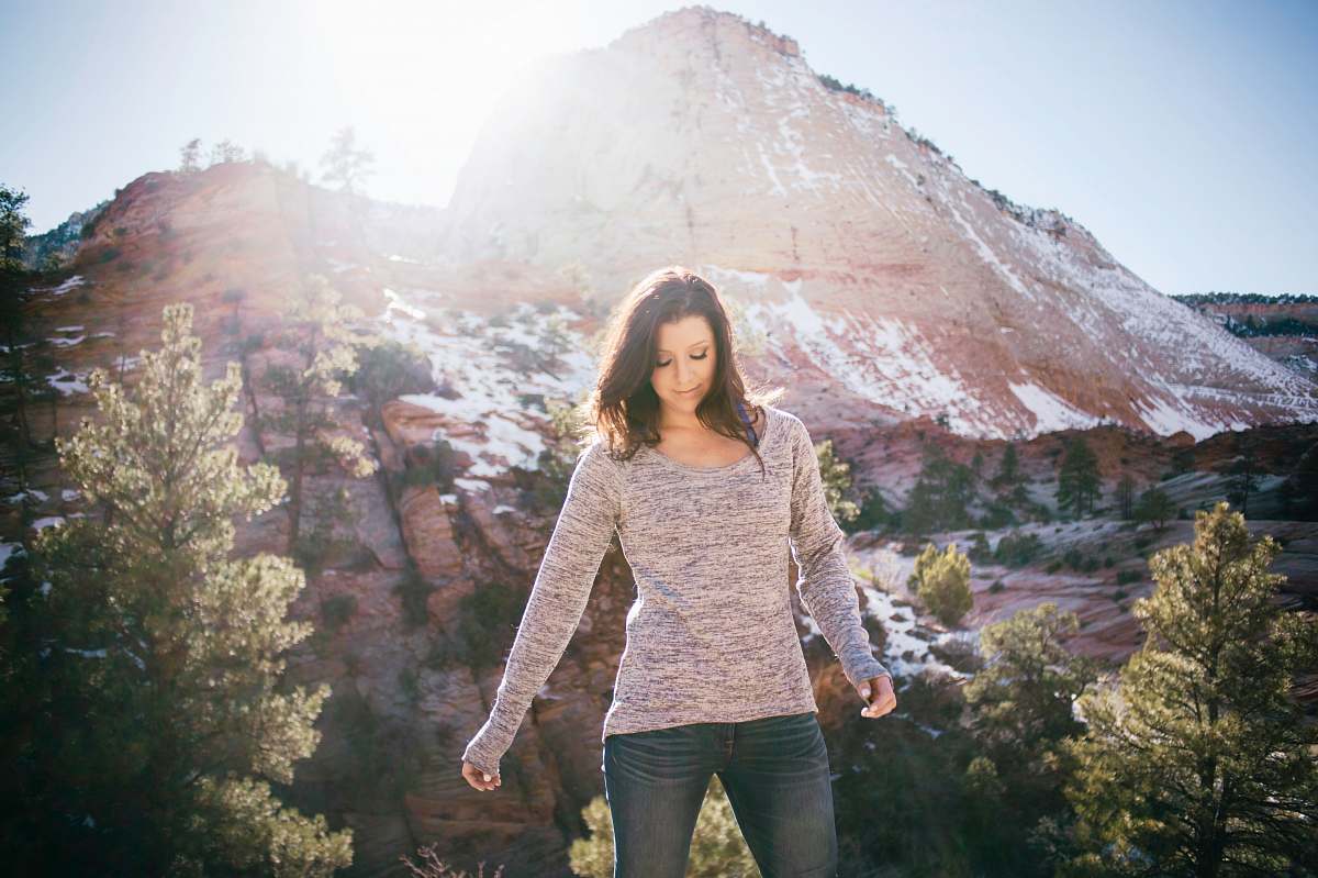 people woman standing on front of mountain sweater