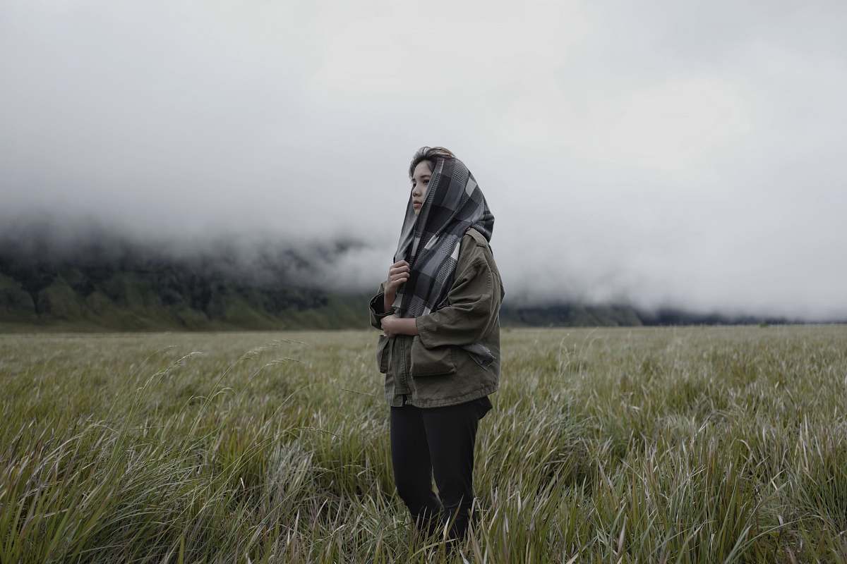 person woman standing on grasses people