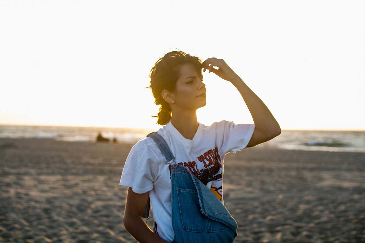 people woman standing on seashore holding her head person