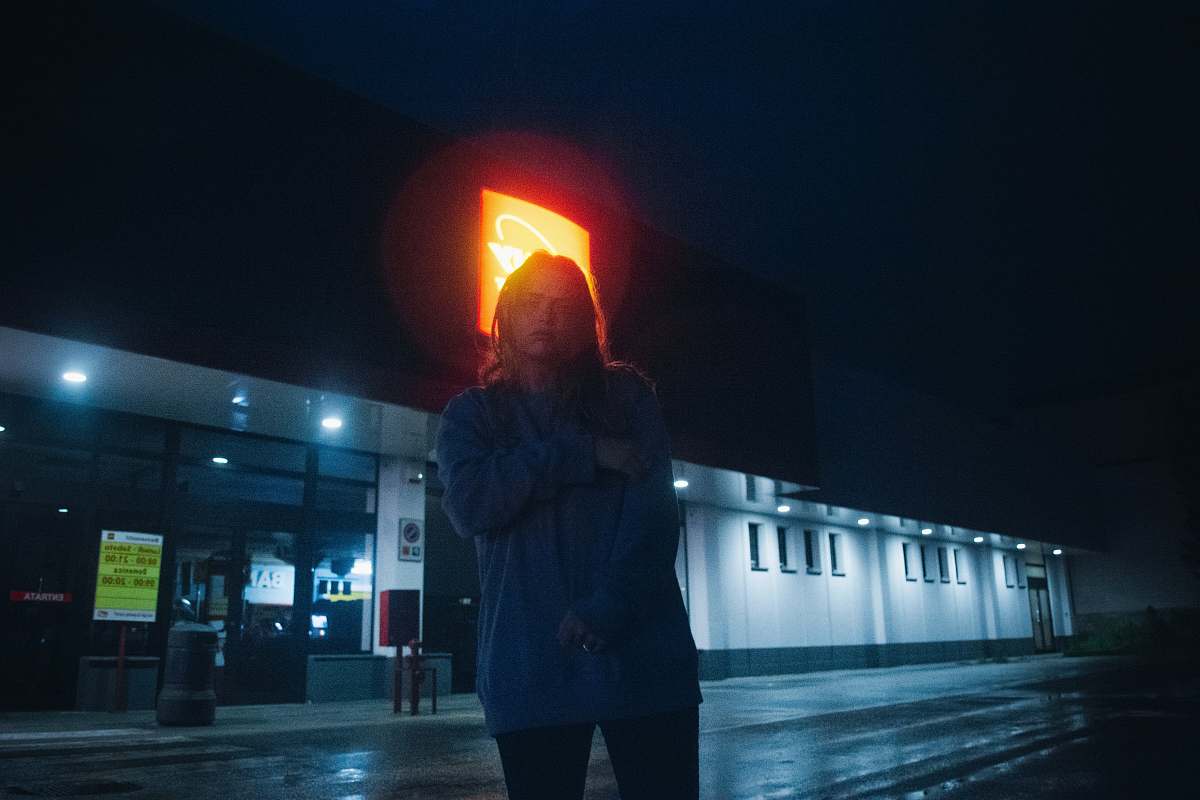 people woman standing on street during night time person