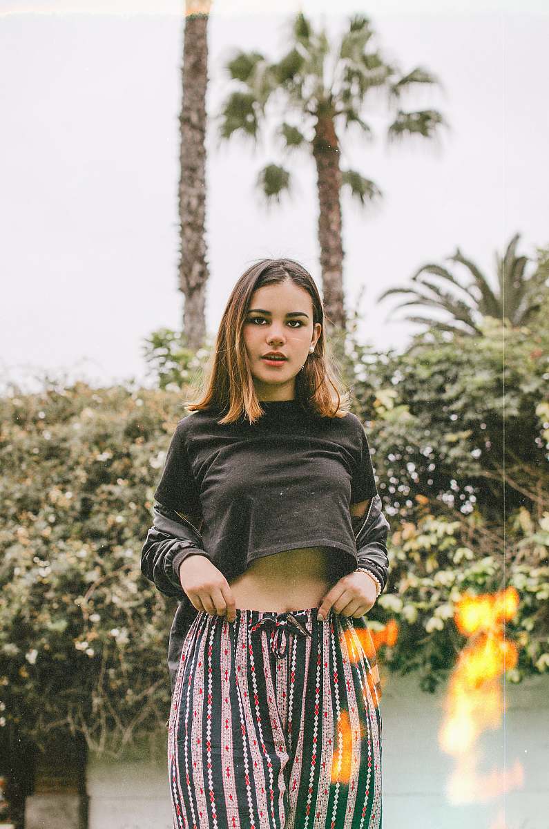 people woman standing while wearing black crop top person
