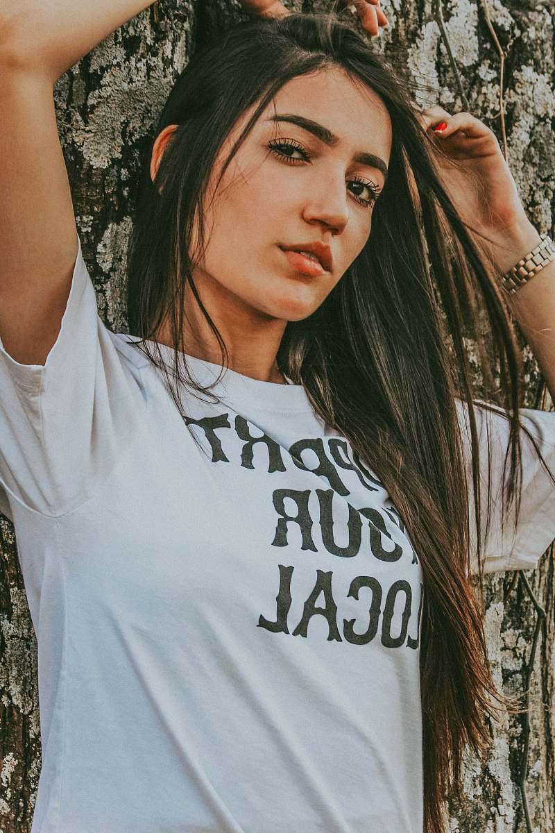 people woman standing while wearing white t-shirt person