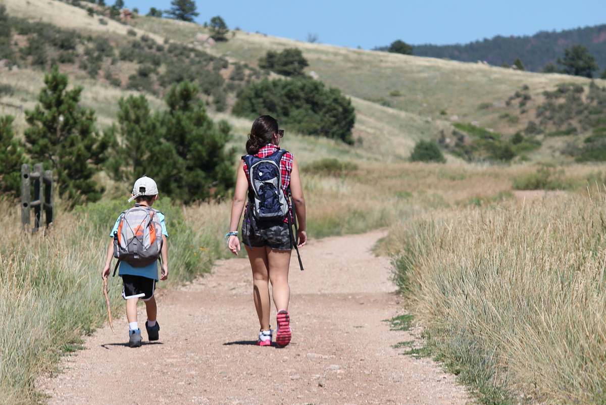 person woman walking beside holding walking while holding stick people