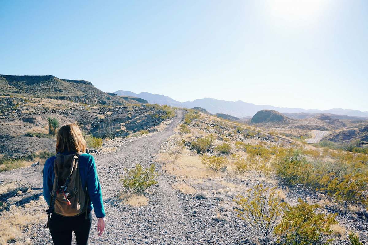 people woman walking on pathway with green grass person