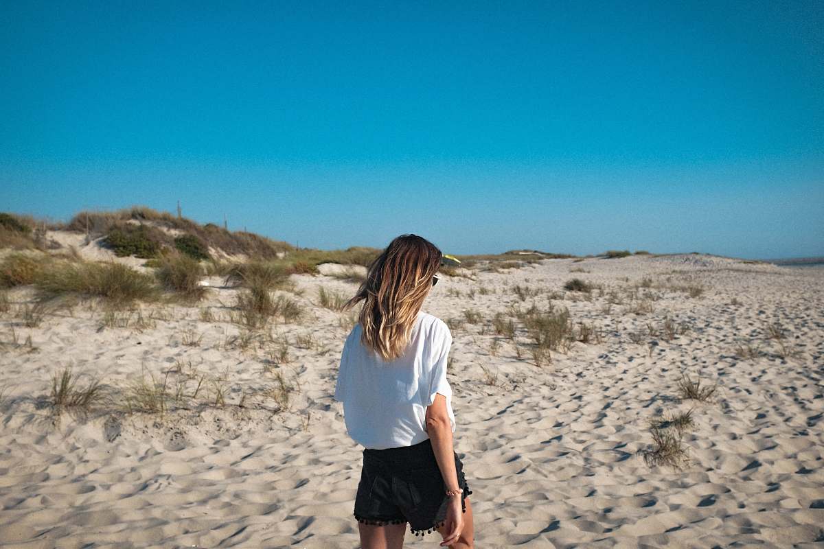 people woman walking on sand pavement person