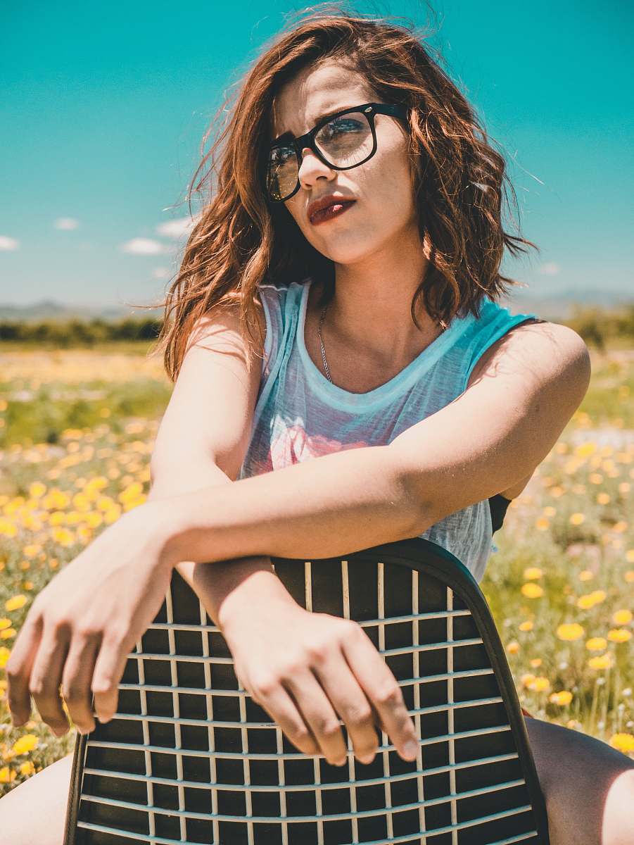 person woman wearing black eyeglasses sitting on the black padded chair people