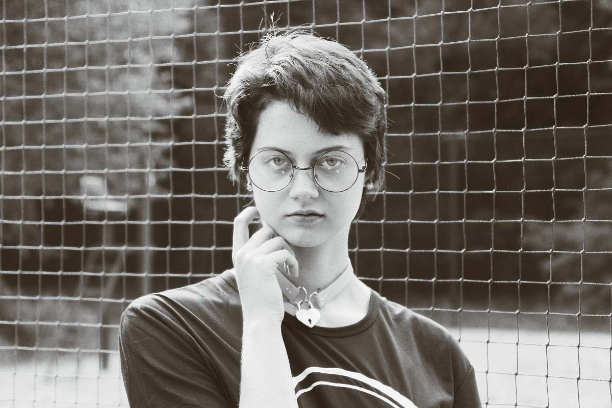 people woman wearing black shirt near screen person