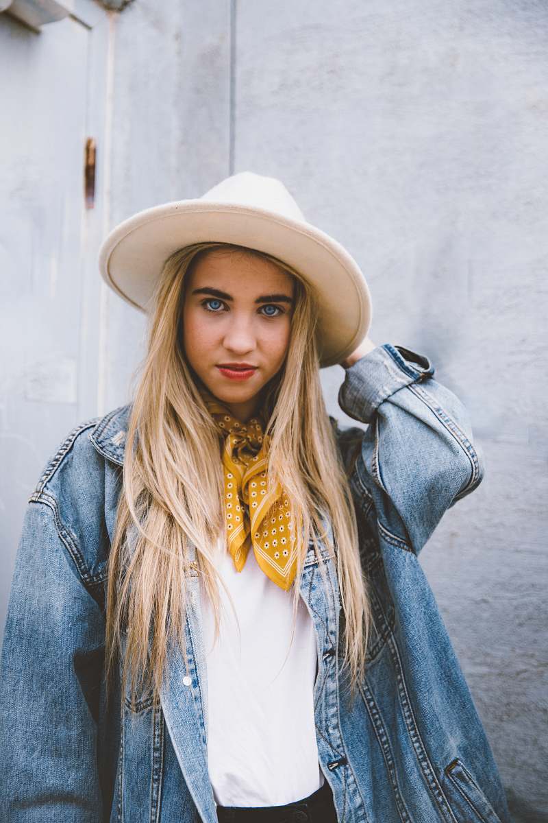 people woman wearing blue denim jacket and white hat hat