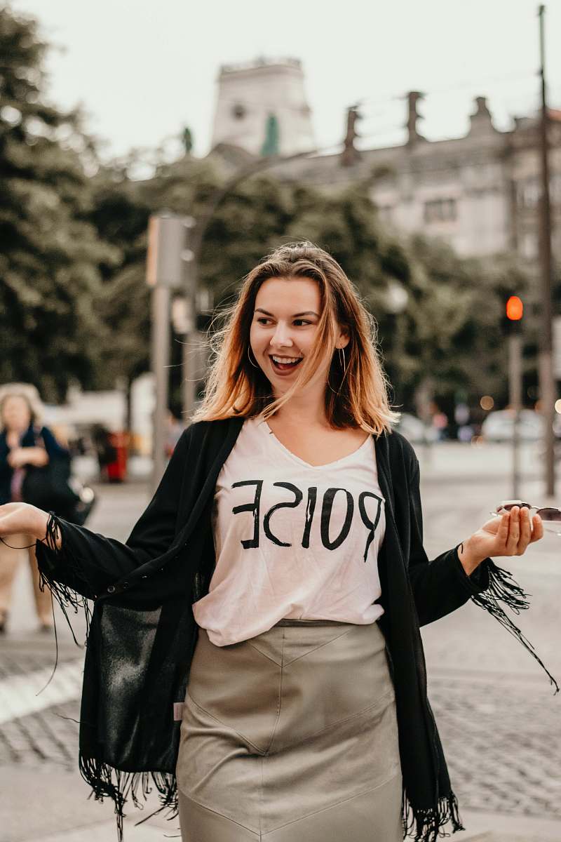 person woman wearing cardigan holding sunglasses people